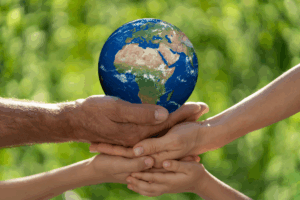 Family Holding Earth Planet in Hands for Toiro